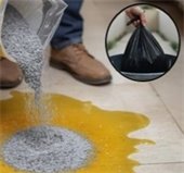 Cleaning up a cooking oil spill with cat litter and then throwing it in the garbage.